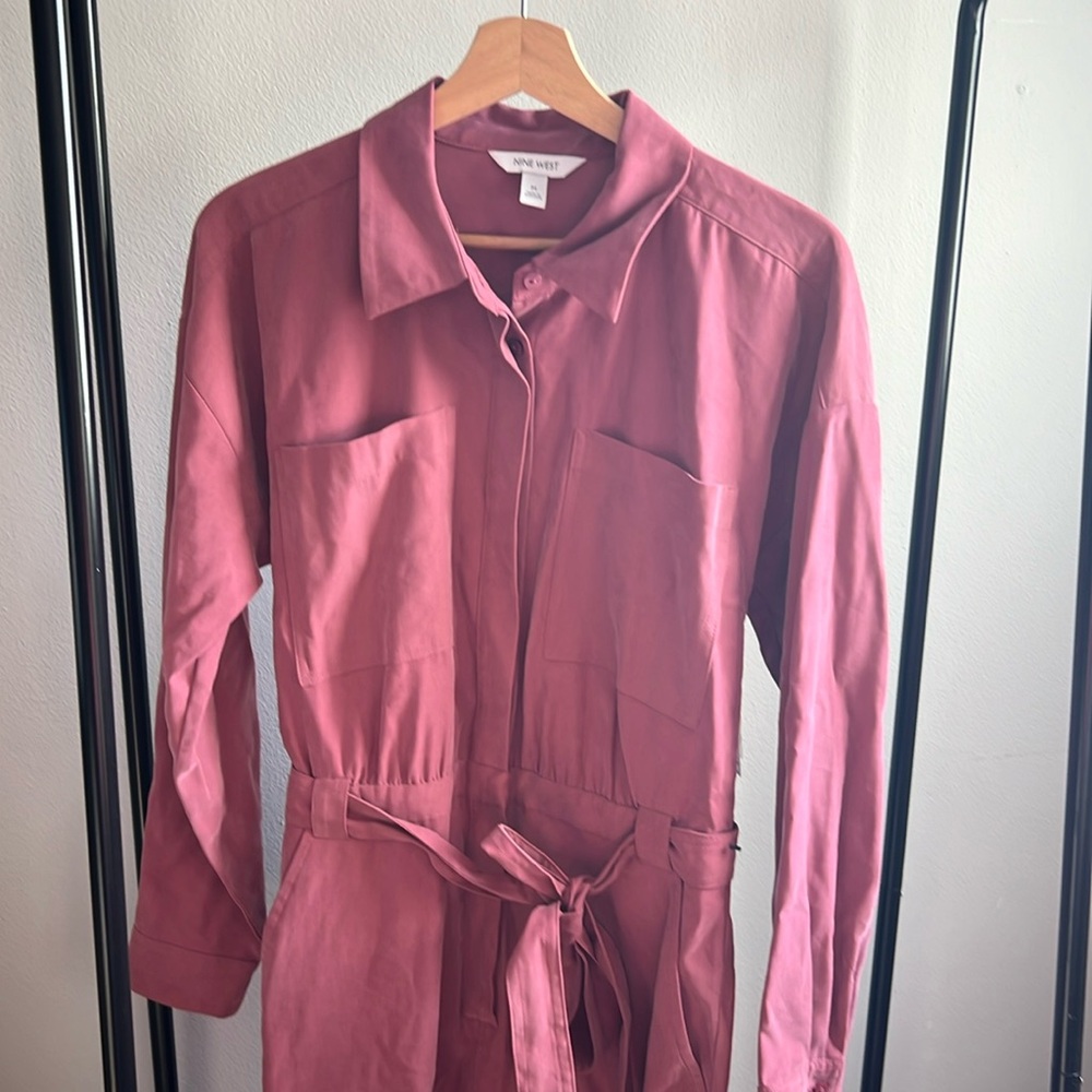 Pink jumpsuit with button up top and tie belted waist.